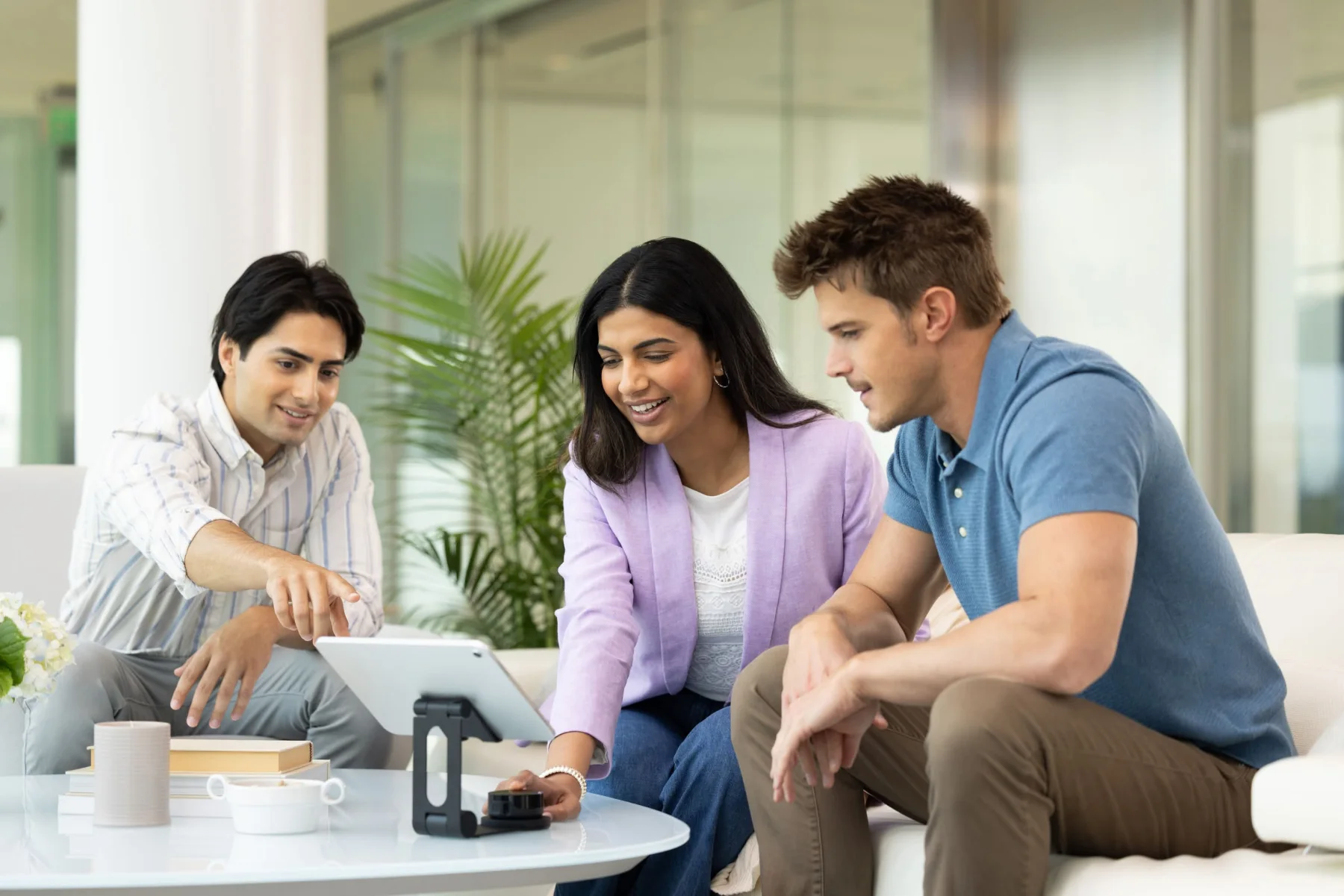 Wellness professionals collaborating around a tablet